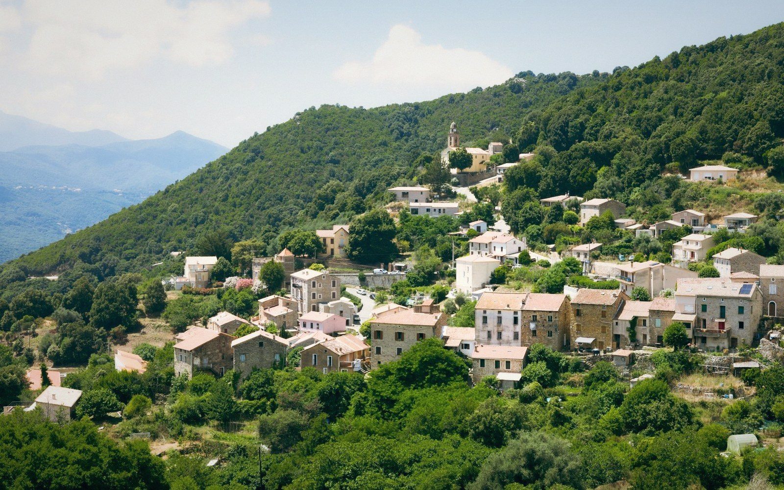 A village of dressed grey granite blocks stacked on a slope